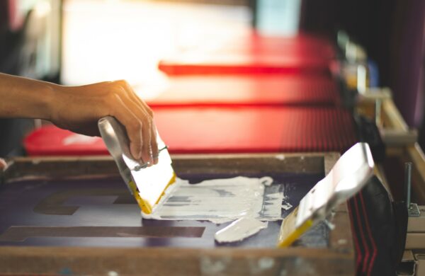 Vorführung der Drucktechnik - Siebdruck, Farbauftrag von Hand